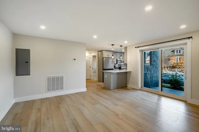 a view of a kitchen with wooden floor and a ceiling fan