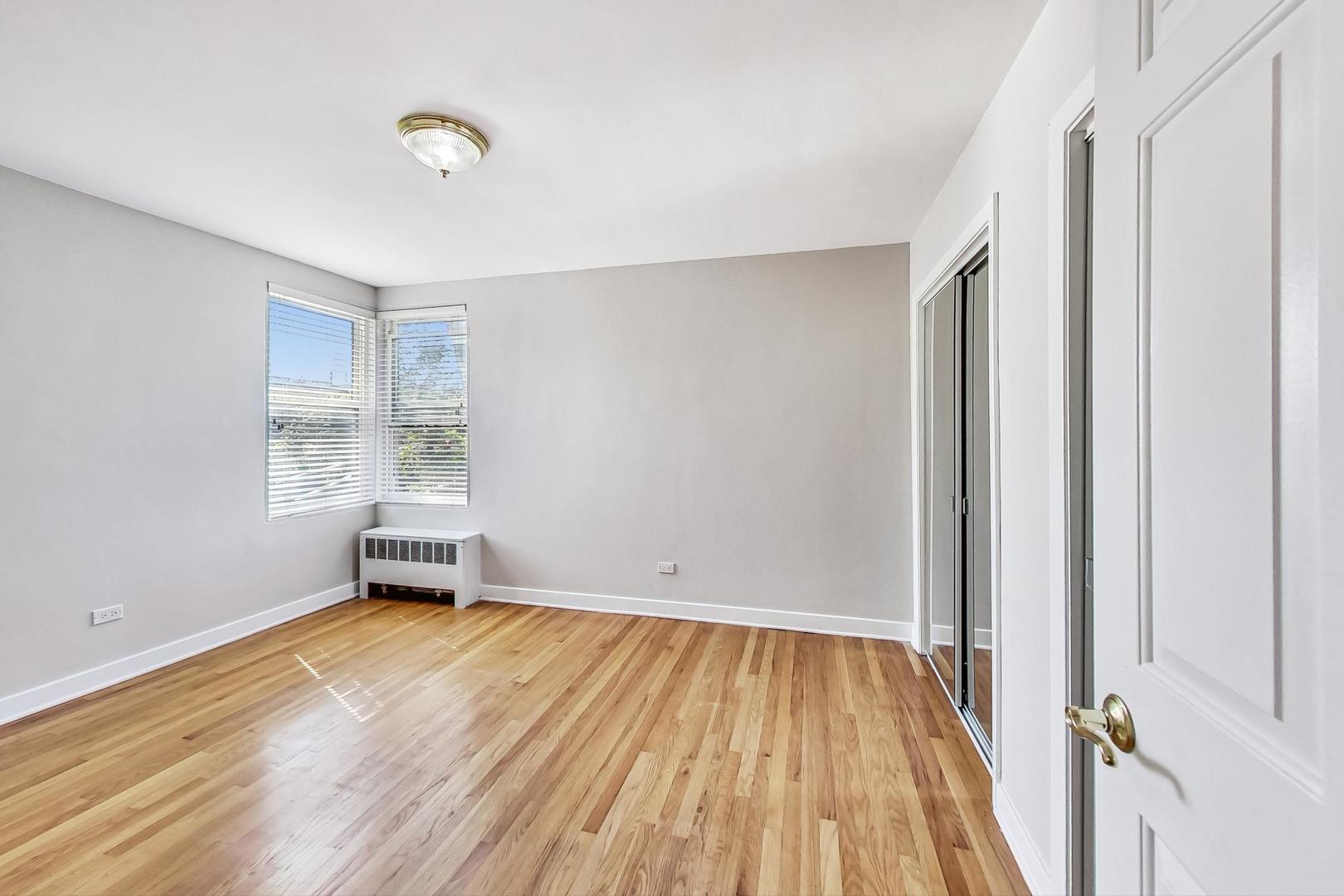 7400 North Sheridan Road, Unit 2 Chicago, IL 60626 - Photo 13 of 23 wooden floor in an empty room with a window