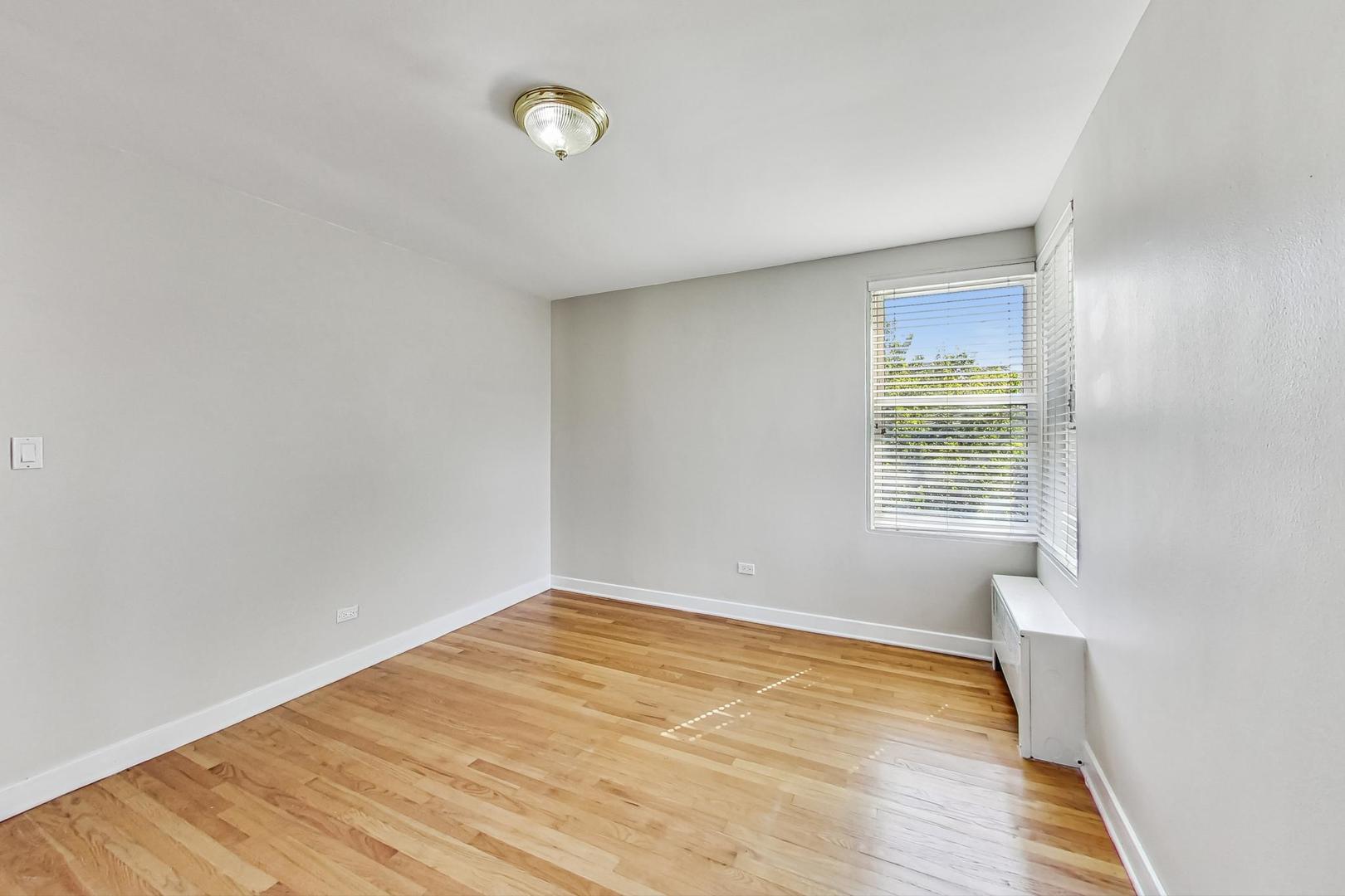 7400 North Sheridan Road, Unit 2 Chicago, IL 60626 - Photo 14 of 23 an empty room with wooden floor and windows