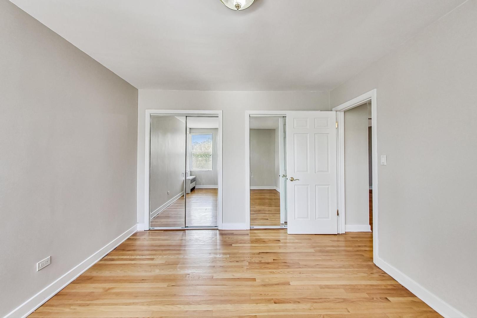 7400 North Sheridan Road, Unit 2 Chicago, IL 60626 - Photo 15 of 23 a view of empty room with wooden floor and fan