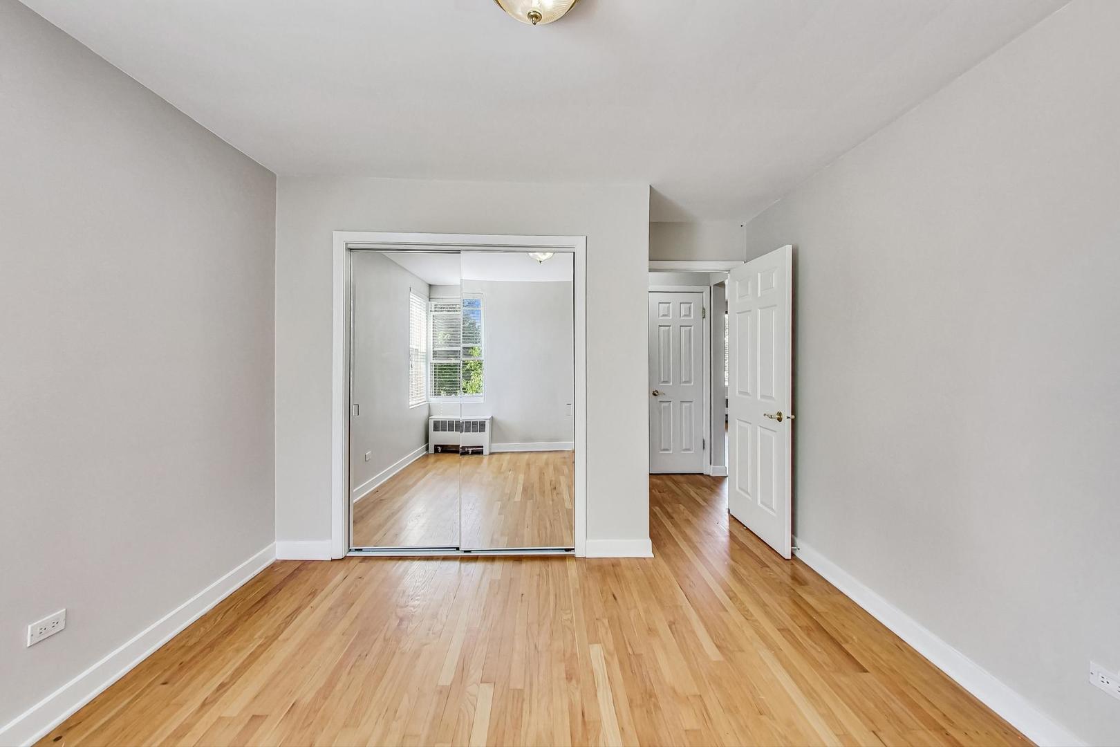7400 North Sheridan Road, Unit 2 Chicago, IL 60626 - Photo 18 of 23 a view of a room with wooden floor and a hallway