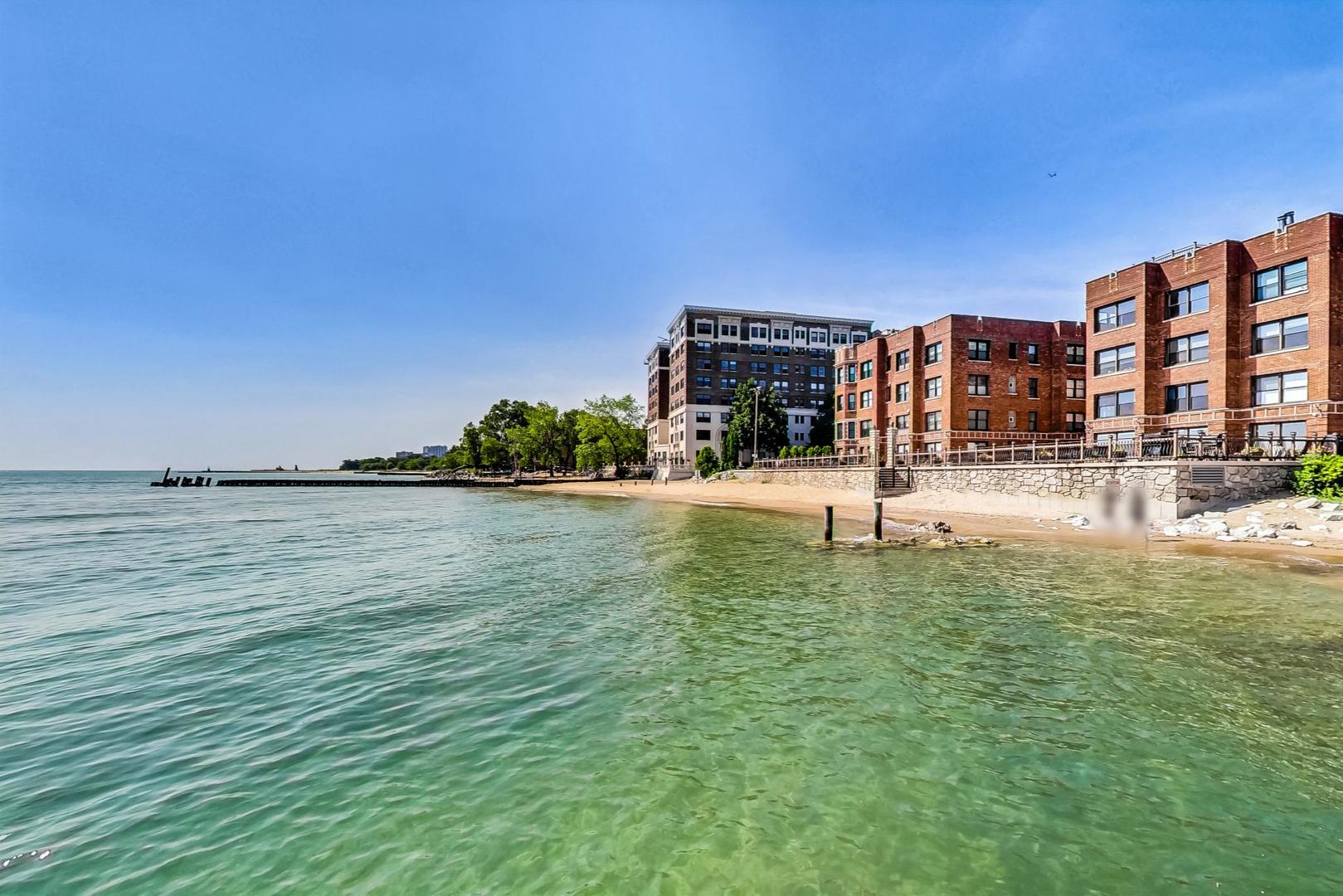 7400 North Sheridan Road, Unit 2 Chicago, IL 60626 - Photo 21 of 23 a view of a lake with a building and a big yard