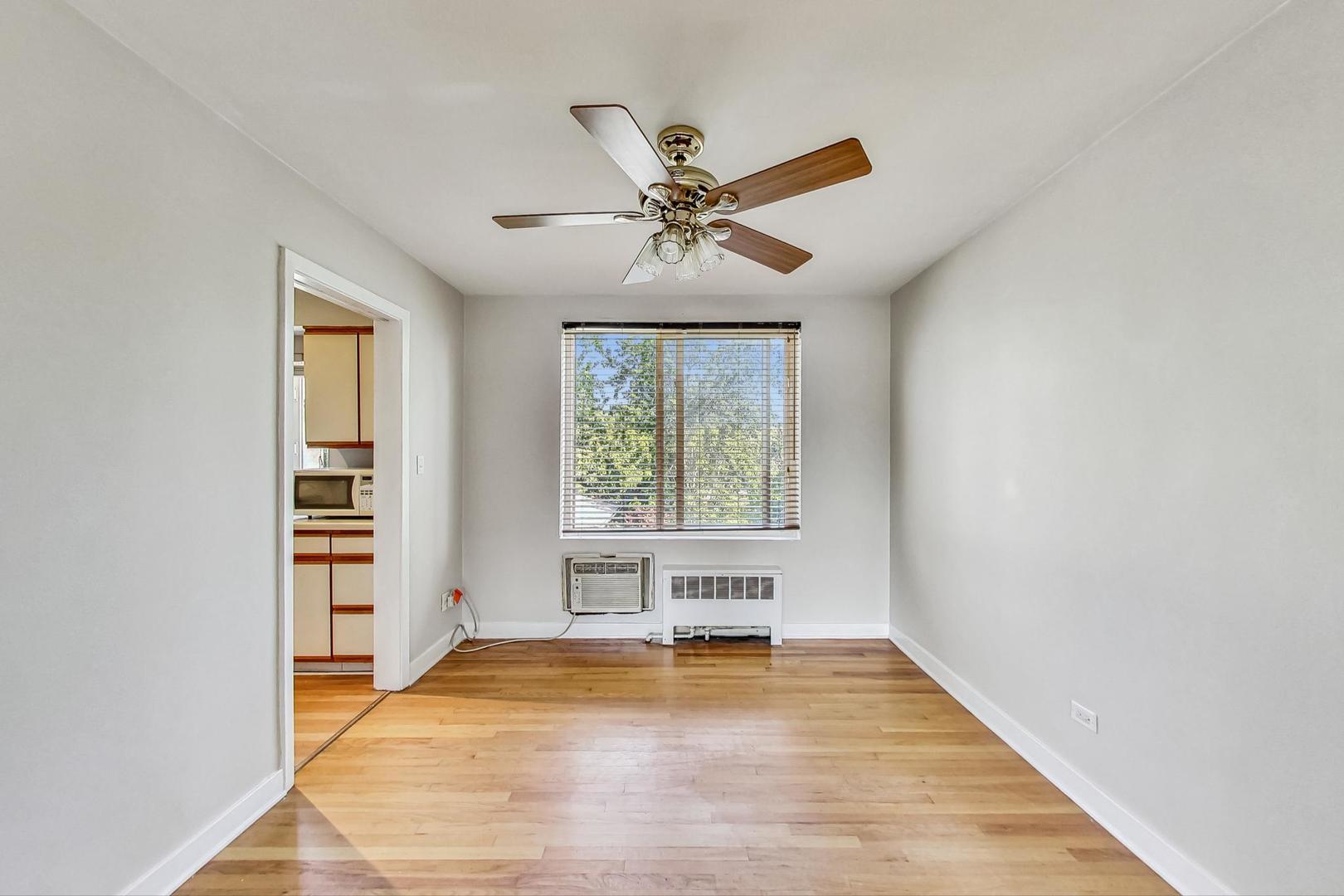 7400 North Sheridan Road, Unit 2 Chicago, IL 60626 - Photo 7 of 23 a view of livingroom with hardwood floor and a ceiling fan