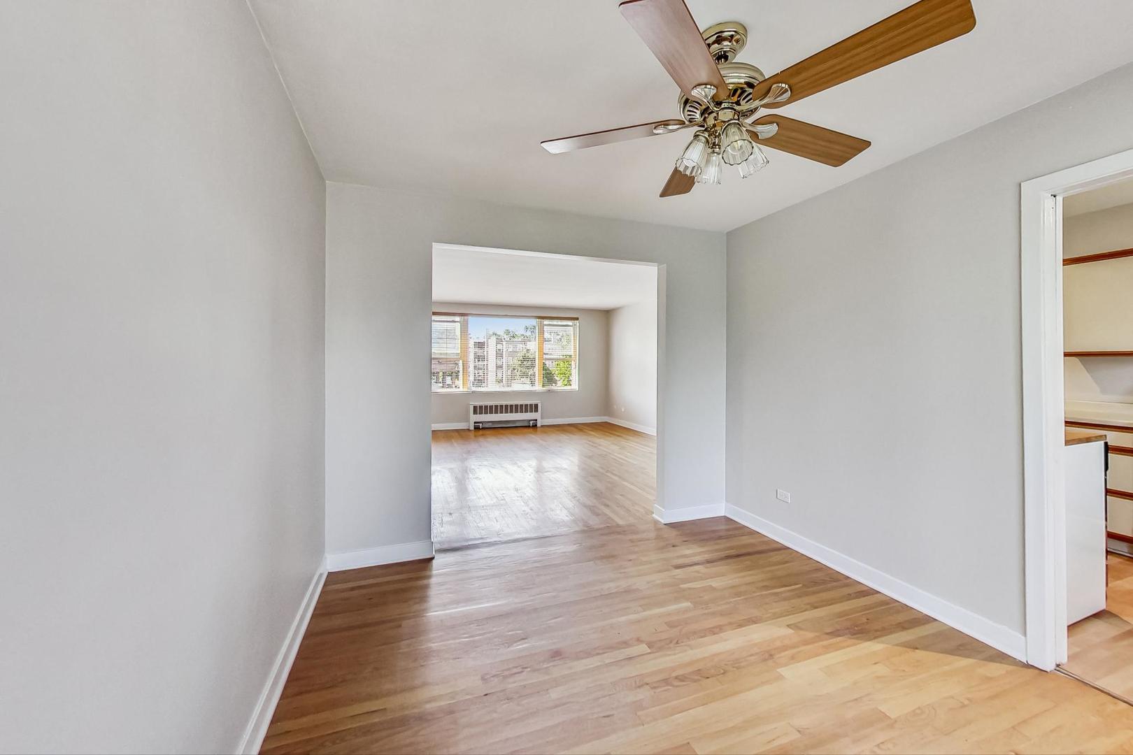 7400 North Sheridan Road, Unit 2 Chicago, IL 60626 - Photo 8 of 23 a view of an empty room with window and wooden floor