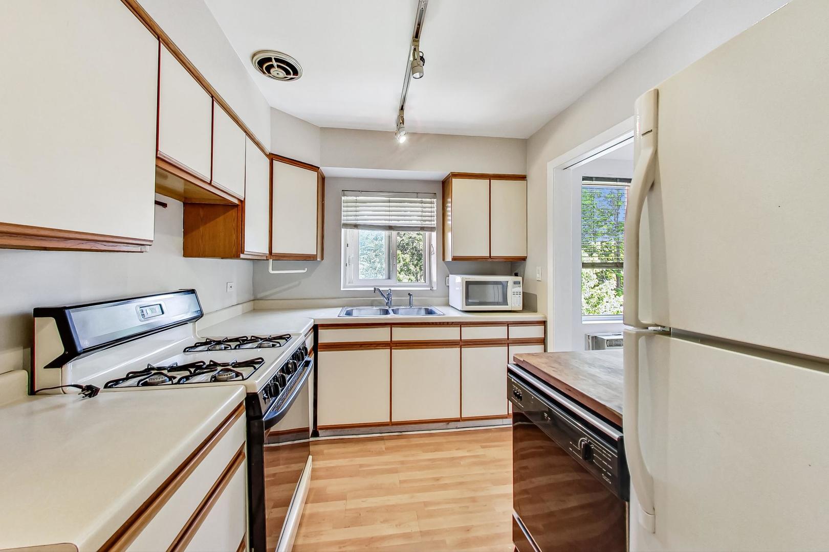 7400 North Sheridan Road, Unit 2 Chicago, IL 60626 - Photo 10 of 23 a kitchen with stainless steel appliances granite countertop a stove a sink and a refrigerator