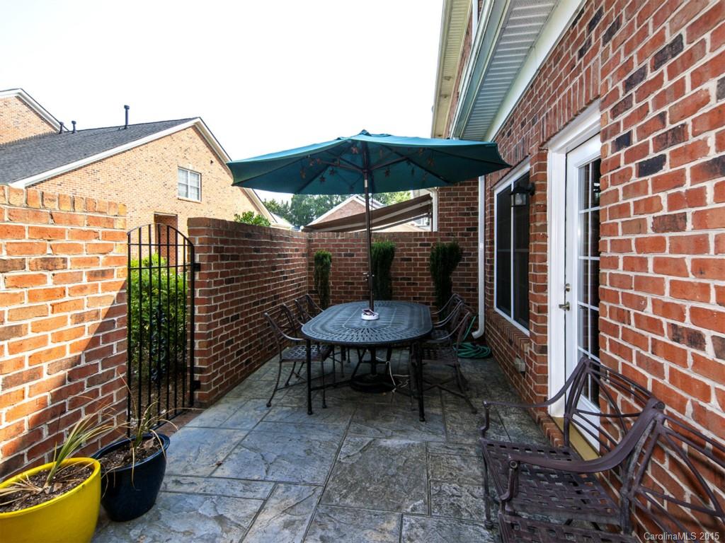 608 Crosswater Lane, Unit 608 Fort Mill, SC 29708 - Photo 17 of 20 a backyard of a house with table and chairs
