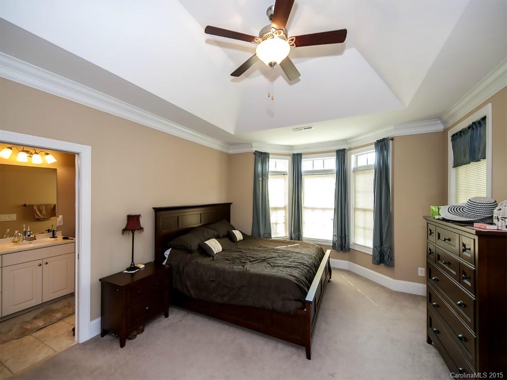 608 Crosswater Lane, Unit 608 Fort Mill, SC 29708 - Photo 6 of 20 a bedroom with a bed and a chandelier