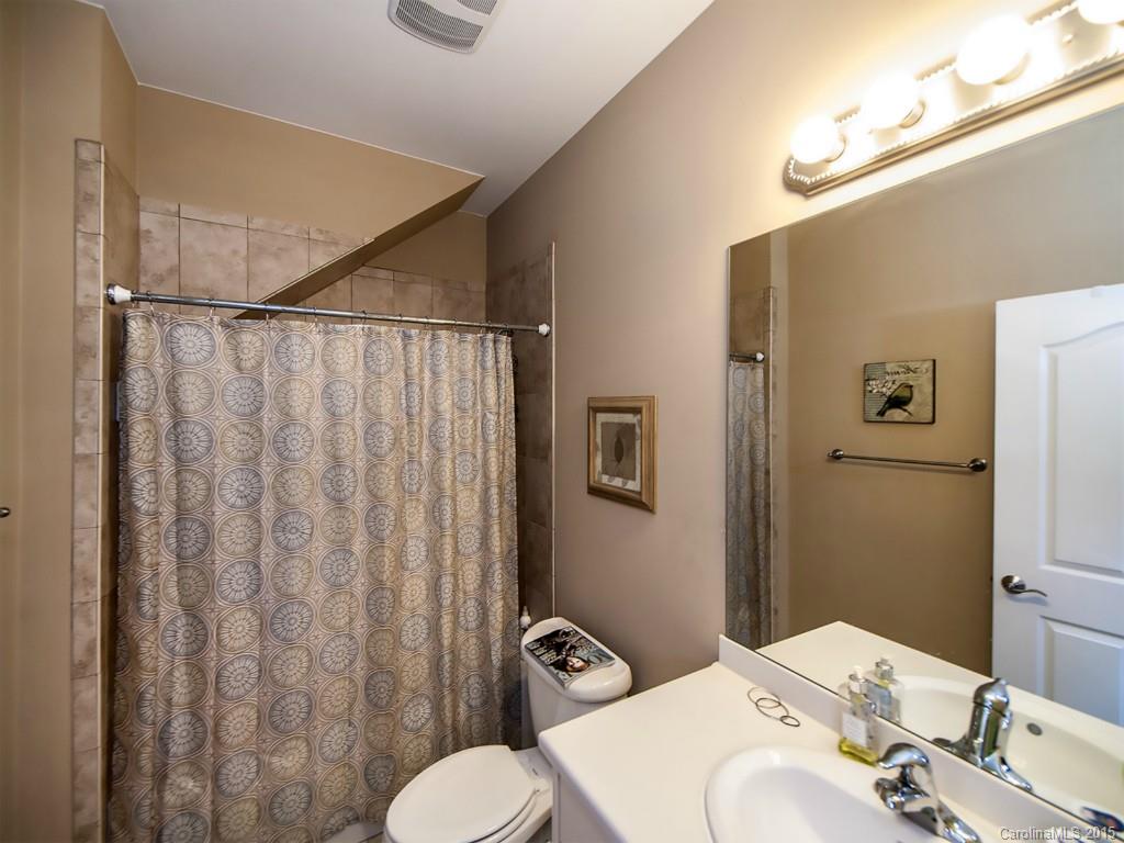 608 Crosswater Lane, Unit 608 Fort Mill, SC 29708 - Photo 10 of 20 a bathroom with a sink a toilet and shower curtain