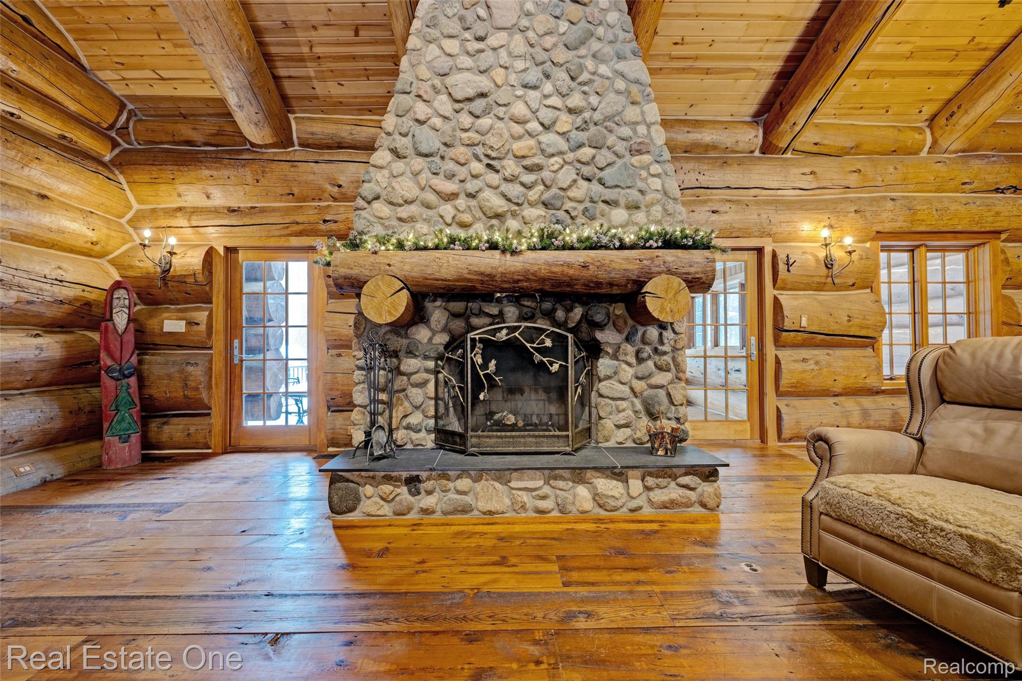 4340 Lahring Road Holly, MI 48442 - Photo 9 of 89 Living room featuring wood-type flooring, log walls, a stone fireplace, and wooden ceiling