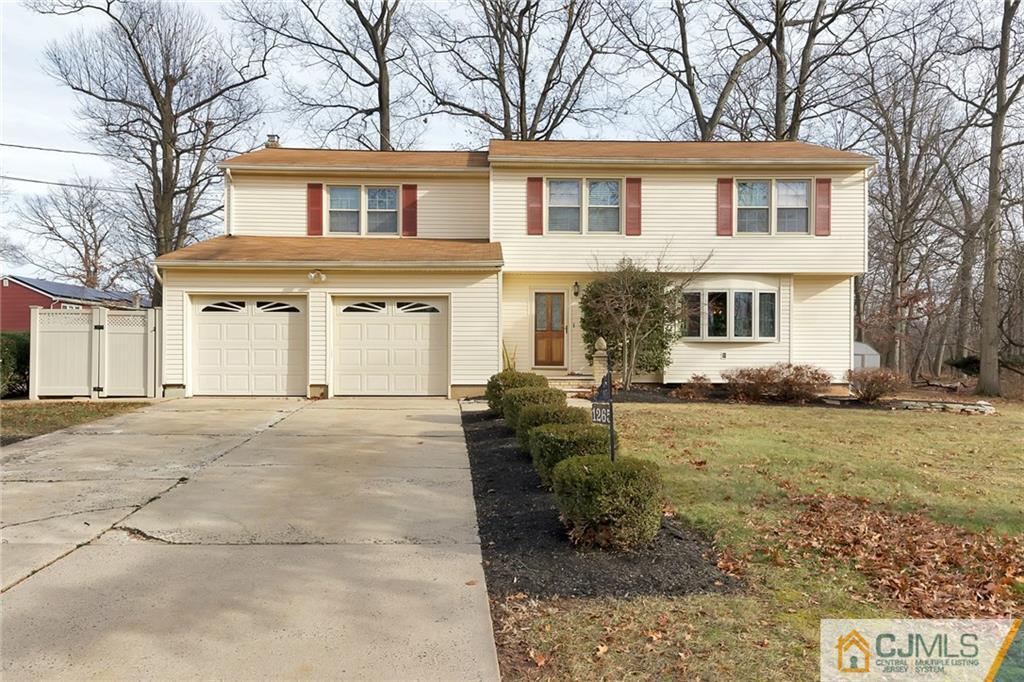 1265 Brookside Road Piscataway, NJ 08854 - Photo 1 of 25 a front view of a house with garden