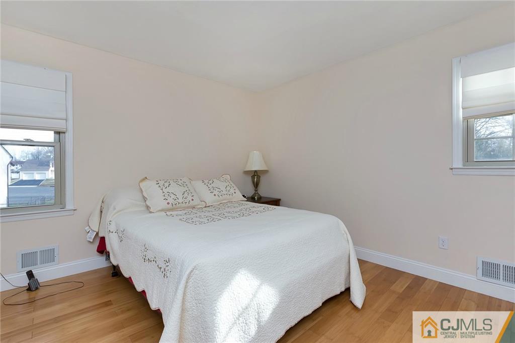 1265 Brookside Road Piscataway, NJ 08854 - Photo 14 of 25 a bedroom with a bed and wooden floor