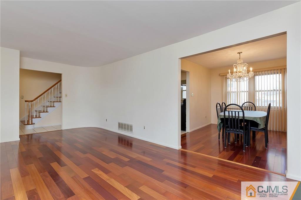 1265 Brookside Road Piscataway, NJ 08854 - Photo 3 of 25 a view of a dining room with furniture and wooden floor