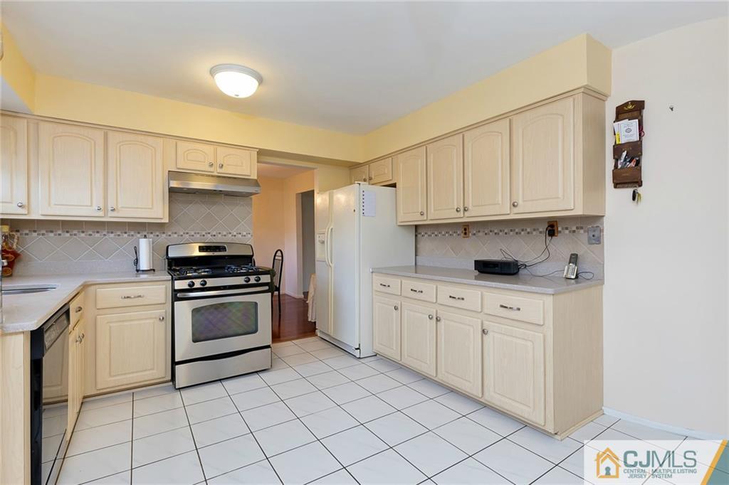 1265 Brookside Road Piscataway, NJ 08854 - Photo 6 of 25 a kitchen with granite countertop cabinets stainless steel appliances and a sink