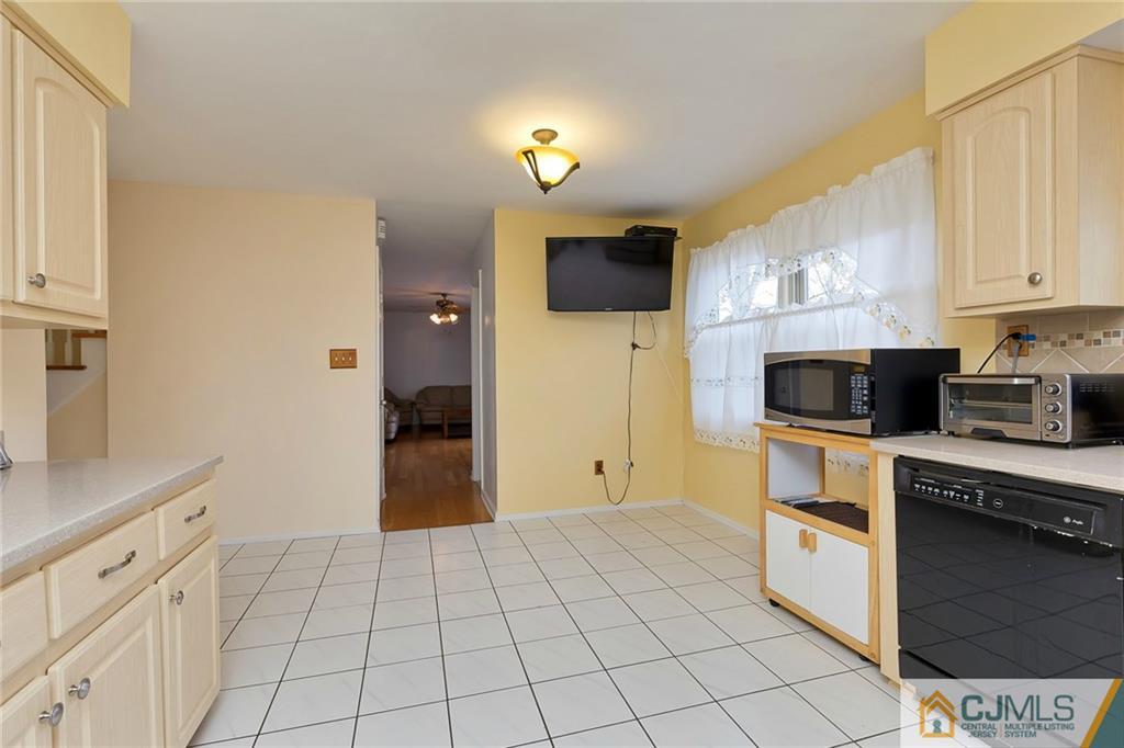 1265 Brookside Road Piscataway, NJ 08854 - Photo 7 of 25 a kitchen with a refrigerator and a stove top oven