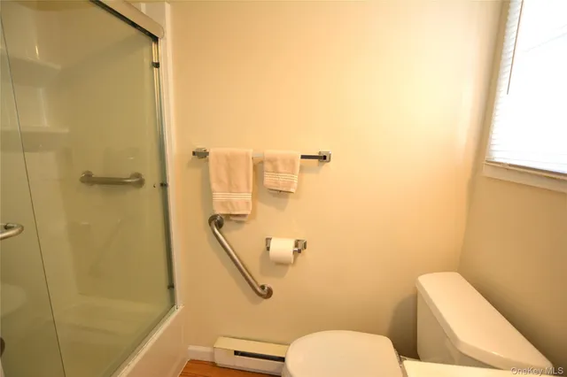 a bathroom with a toilet and a shower