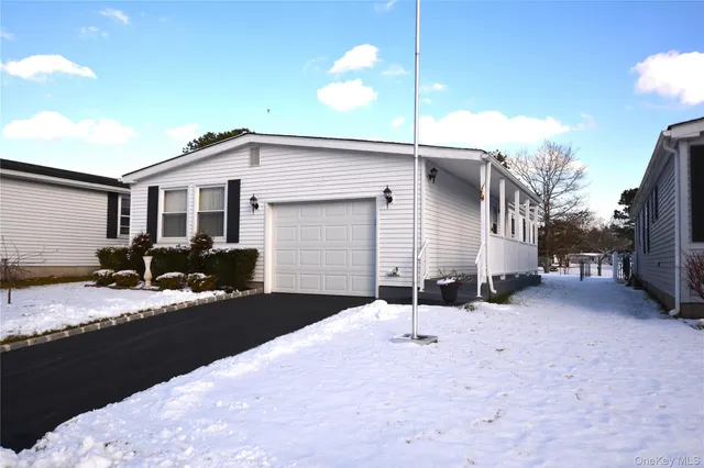 a view of a house with snow on the road