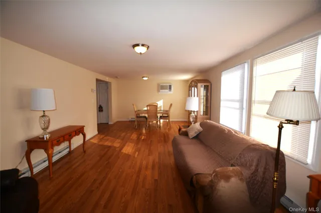 a living room with furniture and a lamp