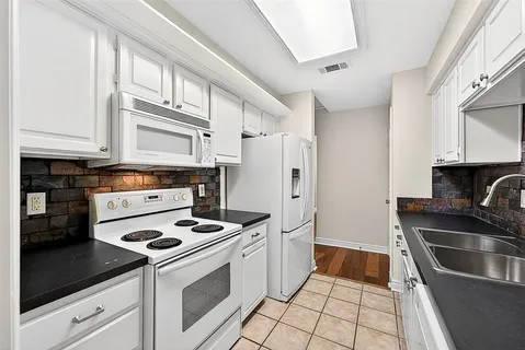 a kitchen with stainless steel appliances a stove a sink and a refrigerator