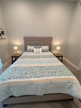 a bedroom with a bed and a night stand