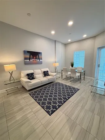 a living room with furniture kitchen view and a table