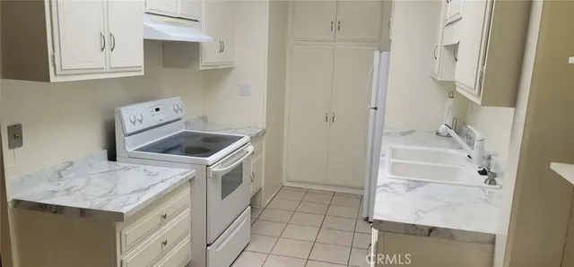 a utility room with cabinets washer and dryer