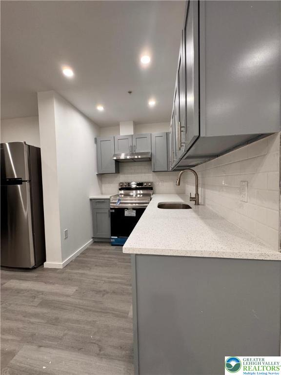 2250 Butler Street, Unit 102 Easton, PA 18042 - Photo 4 of 14 a kitchen with stainless steel appliances granite countertop a sink a stove a refrigerator and a oven