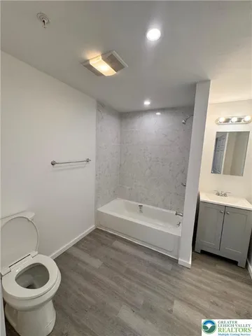 a bathroom with a sink a toilet and bathtub
