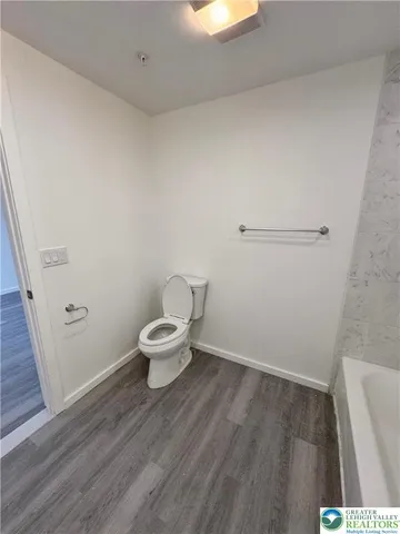 a white toilet sitting next to a white sink