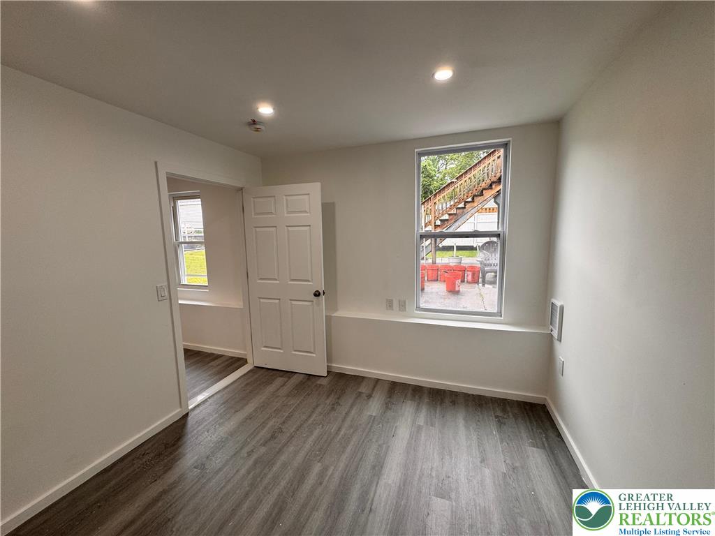 2250 Butler Street, Unit 102 Easton, PA 18042 - Photo 10 of 14 an empty room with wooden floor and windows