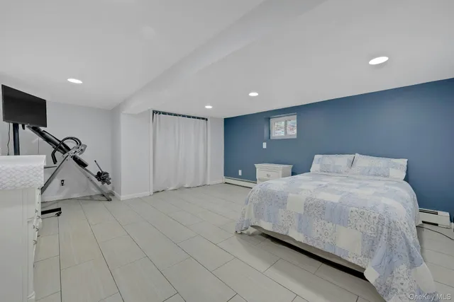 a large bed sitting in a room next to a window