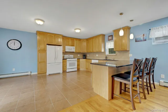 a kitchen with granite countertop chairs and refrigerator
