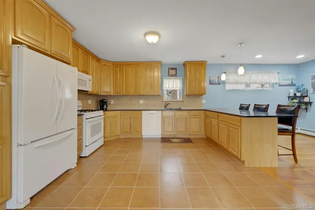 a kitchen with a sink a refrigerator and cabinets