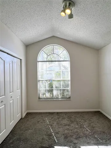 an empty room with a empty space and windows
