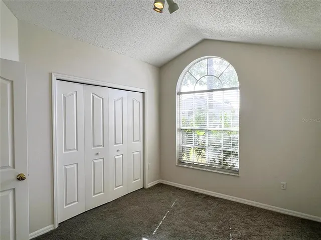 an empty room with windows and natural light