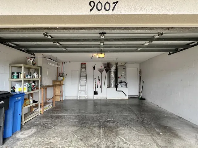 a view of an empty room with a fireplace and a large window