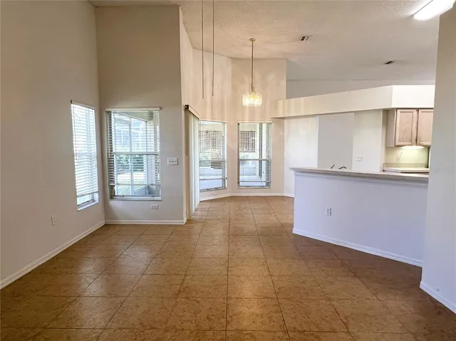 a big room with chandelier and windows