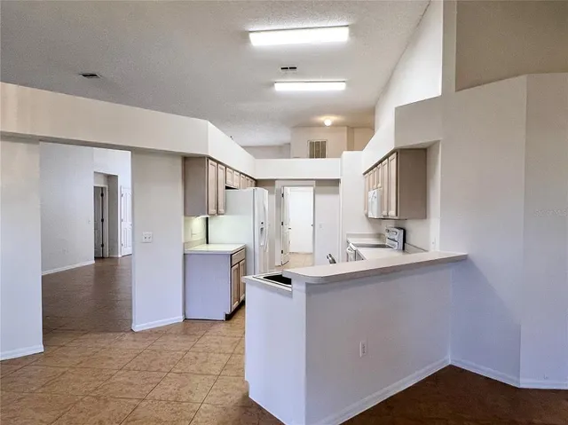a kitchen with kitchen island a sink stainless steel appliances and cabinets