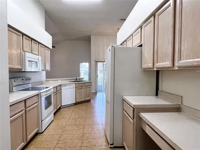 a kitchen with a stove a sink and a refrigerator