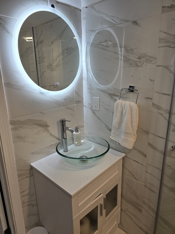 17 Rockingham Road, Unit B Boston, MA 02126 - Photo 2 of 10 a bathroom with a sink and a mirror