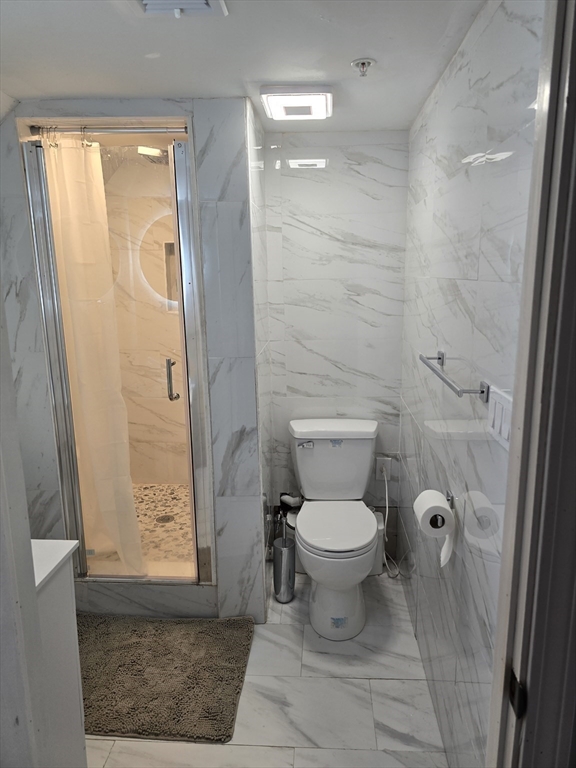 17 Rockingham Road, Unit B Boston, MA 02126 - Photo 4 of 10 a bathroom with a toilet and a shower