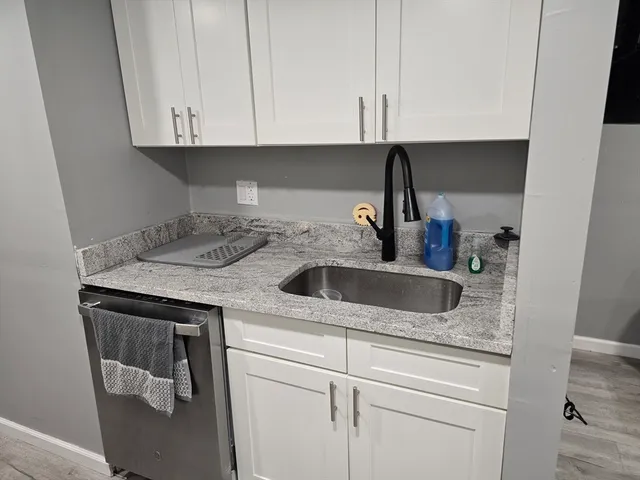 a kitchen with a sink and cabinets