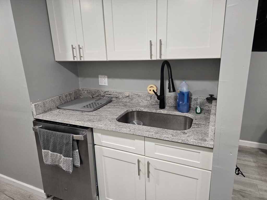 17 Rockingham Road, Unit B Boston, MA 02126 - Photo 7 of 10 a kitchen with a sink and cabinets