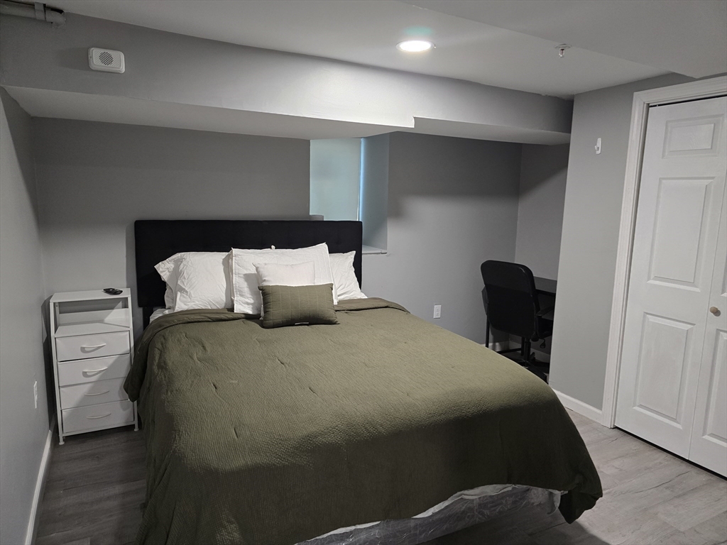 17 Rockingham Road, Unit B Boston, MA 02126 - Photo 8 of 10 a bedroom with a bed and wooden floor