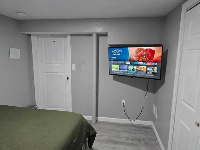 a bedroom with a bed and a flat screen tv