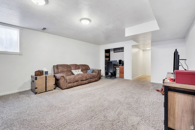 3334 Ute Road St. George, UT 84790 - Photo 25 of 40 Living room with a desk, light colored carpet, and a textured ceiling