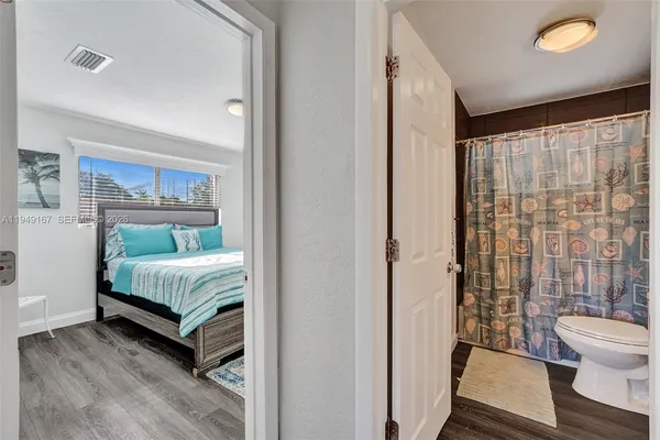 a bedroom with a large bed and a chandelier