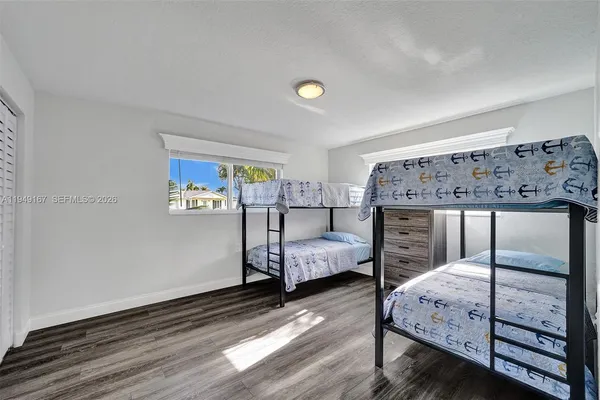 a kitchen with a sink cabinets stainless steel appliances and a window
