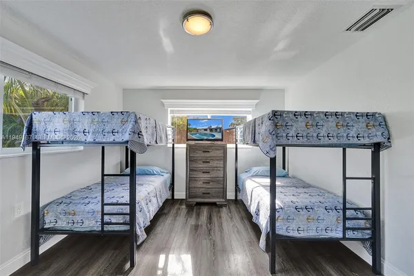a kitchen with white cabinets stainless steel appliances and sink