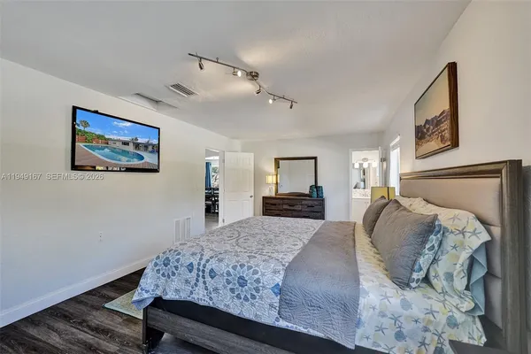 an aerial view of a house with a garden and lake view