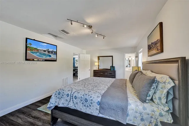 an aerial view of a house with a garden and lake view